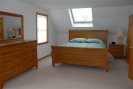 Spacious room with queen bed and a skylite